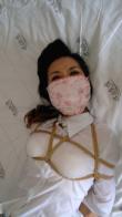 Gaged babe struggling in bed Tied babe is struggling in bed; uniform, high-heels; mouth gag