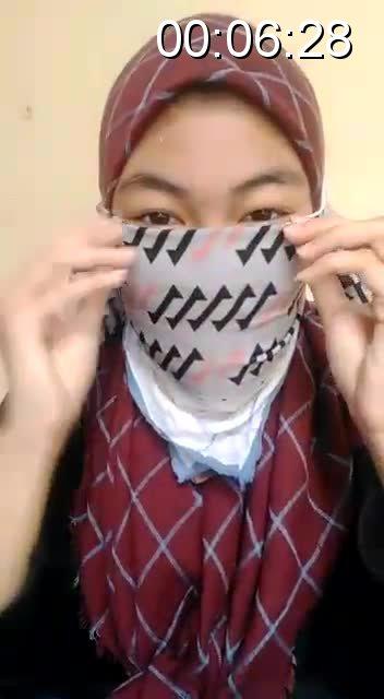 girl self gag an indonesian girl wearing hijab doing a self gag with a multiple layer of handkerchief, the audio is delayed, so sorry.