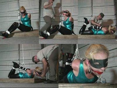 Hapless superhero cruelly hogtied Captured by the Hunter sexy spandex clad superheroine Sierra sits in the sweltering hot garage tightly bound and gagged. She struggles helplessly on the wooden pallet pulling at the brutally tight ropes. Her elbows and wrists are welded completely together and her booted ankles and knees are bound. A large red ball gag has been jammed between her teeth and strapped in tight. The Hunter returns with more ropes and cruelly hogties her on her belly. The hogtie rope is then attached to an overhead rope and pulled taut so that she is into a brutally tight back arch. He leaves her to suffer alone and drooling completely helpless.<br><br><span style='color:#b0b0b0;'>[隐藏文字，购买后可见]</span>