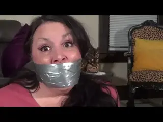 Friday the 13th bondage and panty gagging turn a bout Gina Rae is in her room sorting her laundry when a man with a hockey mask slips in. Gina heads to the laundry room with her dirty clothes and is surprised by the site of the man in her living room. She thinks quick and soon has him bound in duct tape and is gagging him with her dirty panties. She pulls another well worn pair over his head and uses more duct tape to keep the crotch panel on his nose. She chuckles as she leave him to struggle while she starts the washer. She comes back later and his is gone. Suddenly she is grabbed from behind and taped up on camera. She is gagged with 2 pairs of panties and is left to struggle and protest through many layers of duct tape around her head. 