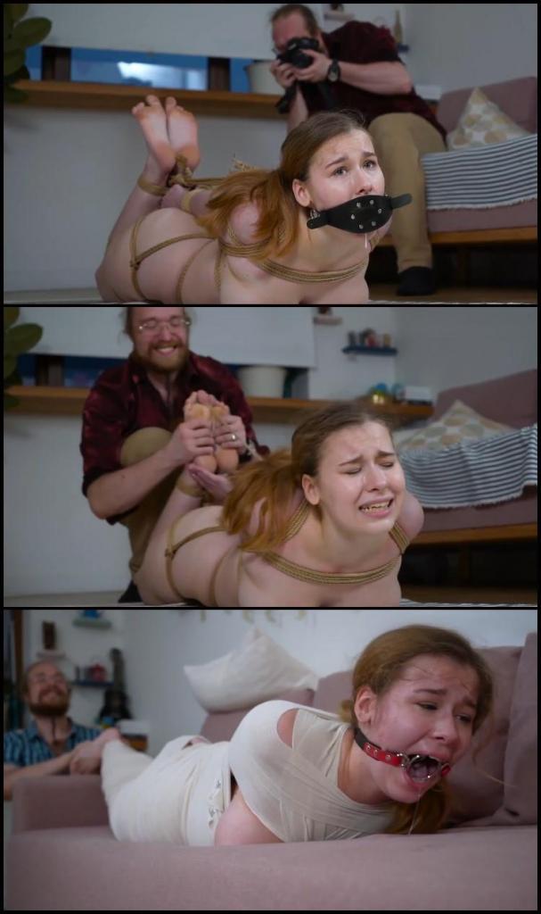 From party girl to obedient slave. Part 2 Two years have passed since Patty’s enslavement.    <br><br><br>Nude, Patty was tightly hog tied on the living room floor, the most insidious aspect of Patty’s bondage was a vibrator tied between her legs that the captor could turn on at a whim. She could hear the people go by and sobbed in frustration at how close freedom was.   <br><br><br>Patty would have just graduated from graduate school and have been  living her life.  Now she is reduced to a bondage slave which is slowing overtaking her and reducing her former life to a mere memory. Fiddler was calmly playing ukulele when decided to play with Patty.  <br><br><br>  <br><br><br>As Patty rocked and gyrated, the captor decides to let her have some fun.  Rolling her onto her side, the captor switches on the vibrator.  Patty arches and convulses as she screams and gyrates her body to the vibrator’s rhythm.  He plays with tied body like a toy, holding it on her knees, swinging back and forth in the air.  <br><br><br>Rolling Patty onto her stomach, the captor turns to Patty’s bound feet and starts to tickle them.  Patty laughs and struggles but the captor does not stop until she’s completely exhausted.  <br><br><br>Three long years have passed since the captor enslaved Patty.  It took Patty little over the last to realize that no one was coming for her and that she now belonged to someone else.  No more doing things on her own, just living using her body to please the captor.  After a while, the hope she had for escape disappeared and what replaced it was a desire to please her master.  The captor could not be any happier and throughout the year would alter between kindness and humiliation to keep Patty a subservient bondage slave. <br><br><br> Laying on the couch as well with her head in the captor’s lap and mummified Patty lays flexing/curling her toes mewing and struggling to get the captor’s attention.  Patty attitude is more playful and subservient now as she gyrates and moves jiggling the nipple clamps attached to her exposed breast. Her hair still tied in a ponytail, Patty sticks her tongue in and out through her gag.  This does not go unnoticed by the captor who strokes Patty’s head and gropes her breast.  Sometimes the captor would play around with Patty’s ring gag mouth stick their finger in there as Patty tried to lick it with her tongue. As Patty groans from this, she occasionally arches and truly struggles in her bondage as if trying to escape.  The captor knew why though.  The head inserted a vibrator in Patty’s mummified prison and as tied up as Patty was it would be a long time before they turned it off. <br><br><br>The captor moves to her toe tied feet, gives Patty long strokes across her feet. Patty laughs and desperately struggles. After a while Fiddler moves to massage Patty’s feet.  When he makes her hop around a living room before finalizing the mumification leaving only her eyes and nose visible.  <br><br><br>Deciding now is the day to take things a little further, the captor makes Patty get up before guiding her by the shoulders and making her to hop to the bedroom.  The captor wanted Patty well rested for the party they plan for her. 