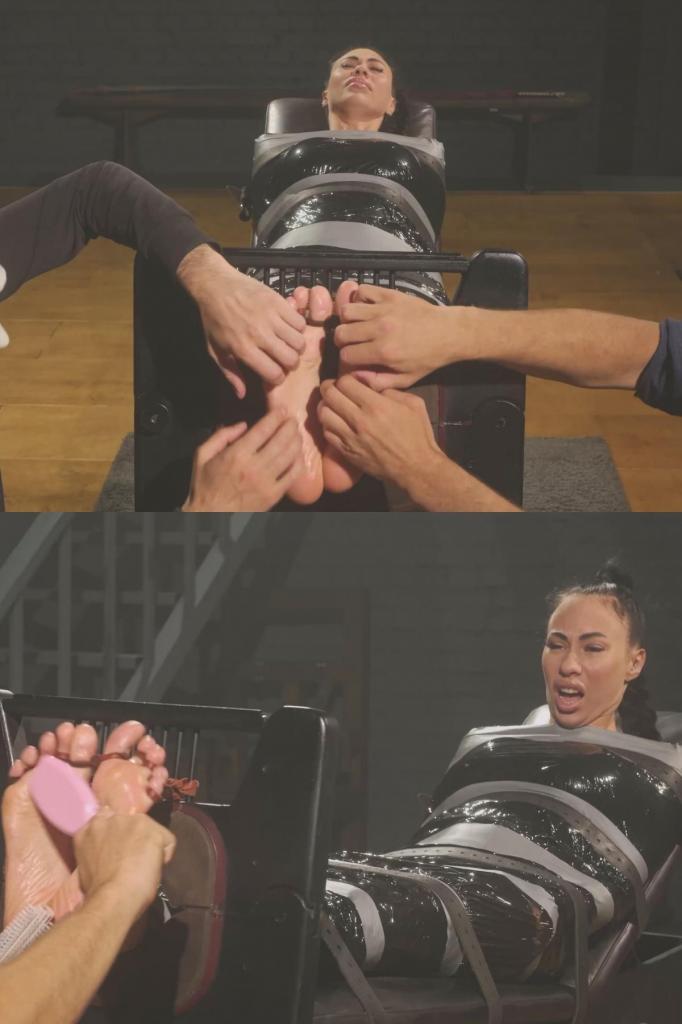 Adriana - Tickling Her Big Size 11 Feet in Stocks 阿德里亚娜被保鲜膜包裹，并被绑在长凳上，双腿伸直，脚趾被固定在脚镣中，动弹不得。她那11码的大脚底完全暴露在外，无法挣脱。<br><br>这段视频记录了整个挠脚过程，重点是阿德里亚娜的大脚。我用双手挠她的脚底，有时一位同事会加入，四手一起挠，以保持力度一致。<br><br>需要说明的是：阿德里亚娜在这次挠脚过程中并不是那种“会爆发式大笑”的类型——她的脚底对痒的反应并不强烈。但她显然很享受我们对她裸露的脚底所做的一切，从触觉和感官的角度来看，她让这种挑逗慢慢积累，而不是突然爆发出惊恐的笑声。<br><br>我们使用了各种挠脚工具，并事先在她的脚底涂油，使它们光滑、湿滑，对每一次触碰都更加敏感。Adriana is wrapped in stretch film and additionally strapped to a bench, fully secured with her bare legs stretched out and her feet locked into stocks. Every toe is fixed in place, leaving her big size 11 soles completely exposed and unable to pull away.<br><br><br>This clip is a full-foot tickling session focused on Adriana's huge feet. I work her soles with both hands, and at times a colleague joins in for four-hand tickling to keep the pressure constant.<br><br><br>One note: Adriana isn't the "explosive laughter" type in this session - her feet weren't extremely ticklish in terms of big reactions. But she clearly enjoys everything we do to her bare soles from a tactile, sensory point of view, letting the teasing build slowly instead of bursting into panic giggles.<br><br><br>We use a variety of tickling tools, and we oil her soles first to make them glossy, slippery, and more sensitive to every touch.