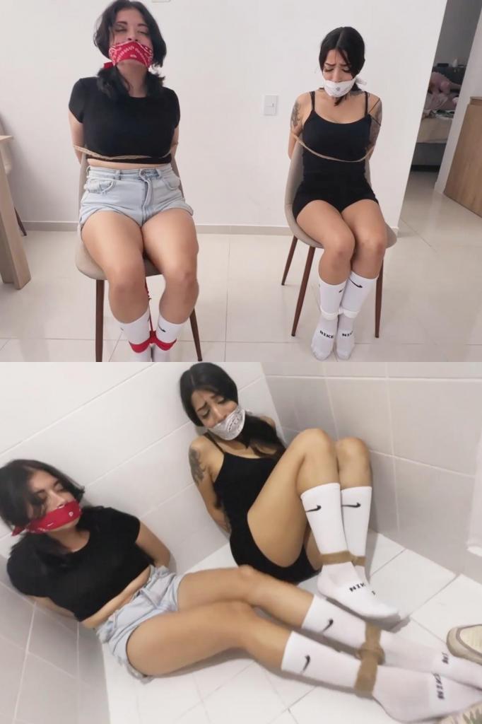 Two College Reporters got caught Snooping Around 西蒙娜和玛拉是两名大学记者，她们正在调查一起关于校长腐败的大案。调查过程中，她们很快被发现，并被绑起来扔进一间后屋，以防被人发现。她们的手腕被反绑在背后，脚踝也被用OTM头巾堵住嘴。<br><br>她们挣扎了几分钟，试图解开绳子，但无济于事。于是她们跳到门口，坐下，试图用脚开门，但还是不行。最终，她们设法解开了双手，然后取下了嘴里的布条。正当她们开始解开脚上的绳子时，她们听到坏人回来查看情况。于是她们赶紧重新绑好自己，堵住嘴，以免被发现试图逃跑。坏人来了，她们假装仍然无助地被绑着。坏人离开后，她们解开绳子，逃了出去。<br><br>最后，她们试图逃跑时再次被抓获，并被绑在椅子上，嘴里又被塞上了OTM头巾。他们挣扎了几分钟，场景结束。Simona and Mara are two college reporters snooping on a big case regarding the principal's corruption. During their snooping, they quickly get caught and are tied up and thrown in a back room to be kept quiet. their wrists are tied behind their back, and their feet tied at the ankles with OTM bandana gags.<br><br><br>they struggle for a few minutes trying to get untied but can't, then hop over to the door, sit and try to open the door with their feet, but can't. Eventually they manage to get their hands untied, then take the gags off too. As they start to untie their feet, they hear the bad guy coming back to check on them. So they quickly retie and gag themselves to not get caught trying to escape. The bad guy comes and they pretend to still be helpless and tied up still. After he leaves, they both untie themselves and escape.<br><br><br>Last but not least the two of them get caught trying to escape and are then tied to chairs with OTM gag again. They struggle for a couple minutes and scene ends.