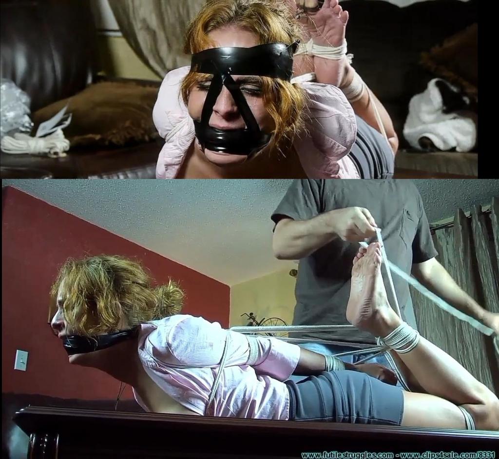 He Throat Fucked me With His Feet, Then Left Me Hogtied - Part 2 This clip starts where Part 1 ended... The intruder tells her that when he unties her wrists to put them behind her back. She complies and he ties them there. He ties her ankles next and then he ties one of the shoelaces into her hair. He spins her around to gag her. He pulls off a little bit of the gauze. He stuffs her mouth with the roll and then uses what he cut off to wrap around her head. He wraps black tape around her head as well. He ties her elbows together and then plants her face down on the coffee table. Soon she's hogtied and her feet are tied as well. He ties her big toes with more shoelaces and then connects them to her hair. He adds more black tape to her face before leaving her. He soon returns though. He has a plastic spatula that he found in the kitchen and some small utility spring . He smacks her feet a few times with the spatula, but isn't satisfied with it as it is plastic and to thin for his liking.he has one for each of her toes minus her to big toes. He decides that he had better be leaving so He removes them and the clip ends shortly after.<br><br>