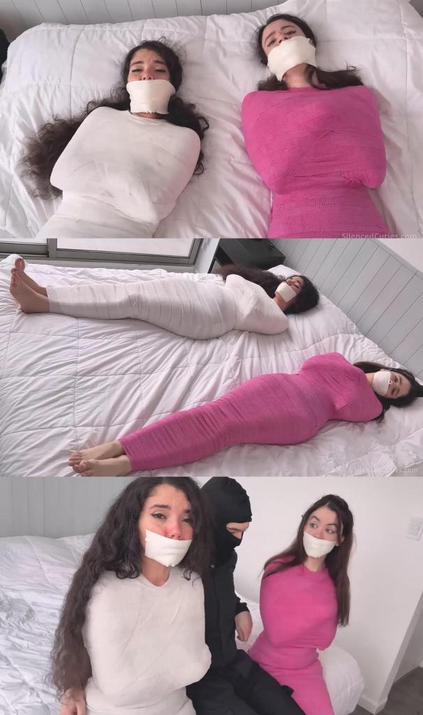 Bondage Treatment?! Nani and Addy Get Tightly MUMMIFIED and Mouth-PACKED! - tapegagged, mummificatio Bondage Treatment?! Nani and Addy Get Tightly MUMMIFIED and Mouth-PACKED! - tapegagged, mummification, struggling, mouth stuffed 可爱的娜妮和美丽的艾迪上完瑜伽课，走到一块写着“免费实验疗法”的牌子前，她们做梦也没想到自己会被裹得严严实实，嘴里塞满了柔软的布，嘴唇也被好几层紧紧的微孔泡沫胶带封住！<br><br>可爱的娜妮和美丽的艾迪在轻松的瑜伽课后伸展身体，笑声不断。伸展间隙，她们看到一块牌子：“免费实验疗法”。出于好奇，她们走了过去。她们受邀参加一次免费体验，便仰面躺在床上，咯咯地笑着。一个戴着面具的男人开始用自粘绷带缠绕艾迪的脚踝，露出她可爱的小脚丫。过了一会儿，两个女孩都被裹得严严实实，从脚踝到脖子都被绷带紧紧地缠了起来。这真的是实验疗法！她们互相看着对方，浑身裹得严严实实，还扭动着露出的可爱小脚丫。<br><br>“这是怎么回事？”她们互相问道。接下来才是最精彩的部分，女孩们！艾迪可爱的嘴唇被一条紧紧的微孔胶带封住。胶带被按压并抚平，牢牢地贴在她的嘴上。嗯！艾迪睁大了漂亮的眼睛，扭动了一下，在胶带后面发出可爱的呻吟。现在轮到娜妮了。她漂亮的嘴唇也被紧紧的微孔胶带封住。他的手指抚平胶带，使其紧贴皮肤，牢牢地粘在她的皮肤上。嗯！她们俩都呻吟着，徒劳地挣扎着，小脚丫在自粘绷带里扭动着。<br><br>过了一会儿，蒙面人拿起她们的东西，开始翻看里面的东西。哦不！嗯！艾迪和娜妮呻吟得更大声了，拼命地挣扎，但自粘绷带把她们束缚得太紧，她们几乎无法左右摇晃。那个做实验的蒙面人拿走了贵重物品，回来抚摸她们被包裹的身体。先从娜妮开始：他的手轻轻地滑过绷带。然后是艾迪：腿、躯干，再回到娜妮。她的脸被捏住，嘴里的布条被勒得更紧。女孩们不停地发出可爱的呻吟和挣扎。两双脚同时被轻柔地抚摸，手指沿着脚踝向上滑动。目光始终停留在艾迪身上，从她的脚到躯干。然后是娜妮。她们俩同时被抚摸了一会儿，动作始终缓慢而温柔。调整并抚平嘴里的布条。<br><br>然后她们被抱起来，坐在床边，一人一边。她们睁大眼睛，挣扎着，被绷紧的胶带勒住的呻吟声被压抑着。她们被拥抱，大腿被拍打，胸前的绷带被摸索着。嗯……！她们的脸被捏住，嘴里的布条再次被勒紧。她们被单独留下一会儿。她们开始挣扎，在床上小跳。她们的脸凑得更近。嘴里的布条擦在一起。一个紧紧的吻！她们不停地挣扎，试图挣脱胶带。<br><br>过了一会儿，蒙面男子撕掉了她们嘴唇上的胶带。先是艾迪。胶带小心翼翼地撕下来……紧接着，一只手捂住了她的嘴。一块柔软的白布被塞进她漂亮的嘴里，直到没有一丝空隙。她的脸颊鼓了起来。“嗯嗯嗯！”为了固定住塞进去的东西，人们用绷紧的胶带封住了她的嘴，然后绕着她的头一圈又一圈地缠绕起来，从下巴一直封到她漂亮的鼻子下方。“嗯嗯嗯！”艾迪一边发出可爱的呻吟，一边看着胶带一层层地贴在她的嘴唇上。<br><br>娜妮徒劳地挣扎着，呻吟着看着这一切。现在轮到她了。胶带被撕下来，一只手捂住了她的嘴，另一块柔软的白布把她漂亮的小嘴完全塞了进去。胶带又缠了起来：一圈又一圈，把堵住她嘴的布紧紧地封在她脸上，一只手还用力地收紧。艾迪看着娜妮的嘴被塞满，嘴唇被封住，不停地呻吟着。当两人嘴里塞好布条，胶带也牢牢固定好后，他们被单独留下。他们呻吟着，互相摩擦着嘴里的布条，徒劳地挣扎着。他们再次躺在床上。他们左右摇晃着身体，互相看着对方，继续挣扎呻吟了很久。When sweet Nani and beautiful Addy finished their yoga class and walked up to a sign that said “Free Experimental Therapy,” they never imagined that they would end up tightly mummified, their mouths stuffed with soft cloth and their lips sealed with layers of tight microfoam tape!<br><br>Sweet Nani and beautiful Addy are stretching and laughing after a very relaxing yoga class. Between stretches they see a sign: “Free Experimental Therapy.” Curious, they walk over. They are invited to a free session and settle onto a bed on their backs, giggling. Addy’s ankles start getting wrapped with cohesive bandage, leaving her adorable feet uncovered, by a masked man. After a while, both girls are completely mummified, tightly wrapped in bandages from the ankles to the neck. This really is experimental therapy! They look at each other, so wrapped up, and wiggle their cute exposed feet.<br><br>"What's going on?" they ask each other. Now comes the best part, girls! Addy’s lovely lips are sealed with a tight strip of microfoam tape. The tape is pressed and smoothed over her mouth. Mmmmpppph! Addy opens her pretty eyes wide, squirms a little and lets out adorable moans behind the tape. Now it’s Nani’s turn. Her pretty lips are gagged with tight microfoam tape too. His fingers smooth the strip, nice and firm, so it stays perfectly stuck to her skin. Mmmmpppph! Both of them moan and struggle uselessly, moving their little feet and twisting inside the self-adherent wrap.<br><br>After a while, the masked man picks up their belongings and starts looking through what’s inside. Oh no! Mmmmpppph! Addy and Nani moan louder and struggle with everything they’ve got, but the cohesive bandage has them so tight they can barely rock side to side. The experimental masked man takes the valuables and comes back to caress those wrapped bodies. Starts with Nani: hands glide softly over the bandage. Then Addy: legs, torso, back to Nani. His face is grabbed to tighten the gag further. The girls don’t stop moaning adorably or struggling. Both pairs of feet are caressed at the same time, softly, sliding a little up the ankles. Focus stays on Addy, from her feet up to her torso. Then Nani. Both are caressed at the same time for a while, always slowly and gently. Readjust and smooth out the gags.<br><br>Then they are lifted and sat on the edge of the bed, one on each side. Eyes wide, struggling, muffled moans behind that firm and stretched tape. They get hugged, patted on the thighs, groped over the bandage at chest level. Mmmmpppph! Their faces are taken and the gags pressed tight once more. They are left alone for a bit. They start struggling and giving little hops on the bed. Their faces lean closer. The gags brush together. A very tight kiss! They keep struggling and trying to work the wrap loose.<br><br>After a while, the tape is peeled off their lips by the masked man. Addy first. It comes off carefully… and right away a hand covers her mouth. A piece of soft white cloth is pushed into her pretty mouth until there is no space left. Her cheeks puff out. Mmmmpppph! To keep that stuffing in place, tightly stretched tape is applied over her mouth, wrapped around and around her head, sealing it from her chin to just below her pretty nose. Mmmmpppphhh! Addy doesn’t stop letting out adorable moans while the layers are smoothed over her lips.<br><br>Nani struggles uselessly and moans watching the whole thing. Now it’s her turn. The tape comes off, a hand covers her mouth, and another piece of soft white cloth stuffs her pretty little mouth completely. Tape again: wrap after wrap, sealing that gag around her face, tightened by hand. Addy keeps moaning as she watches Nani’s mouth get stuffed and her lips sealed. When both of them have the cloth inside and the tape firmly in place, they are left alone. They moan, rub their gags together, struggle uselessly. They are lying on the bed again. They rock from side to side, look at each other, and keep struggling and moaning for a long while.